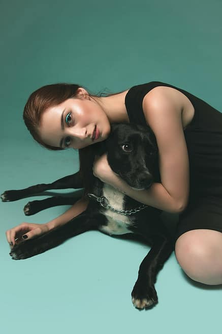 photo of woman hugging a dog
